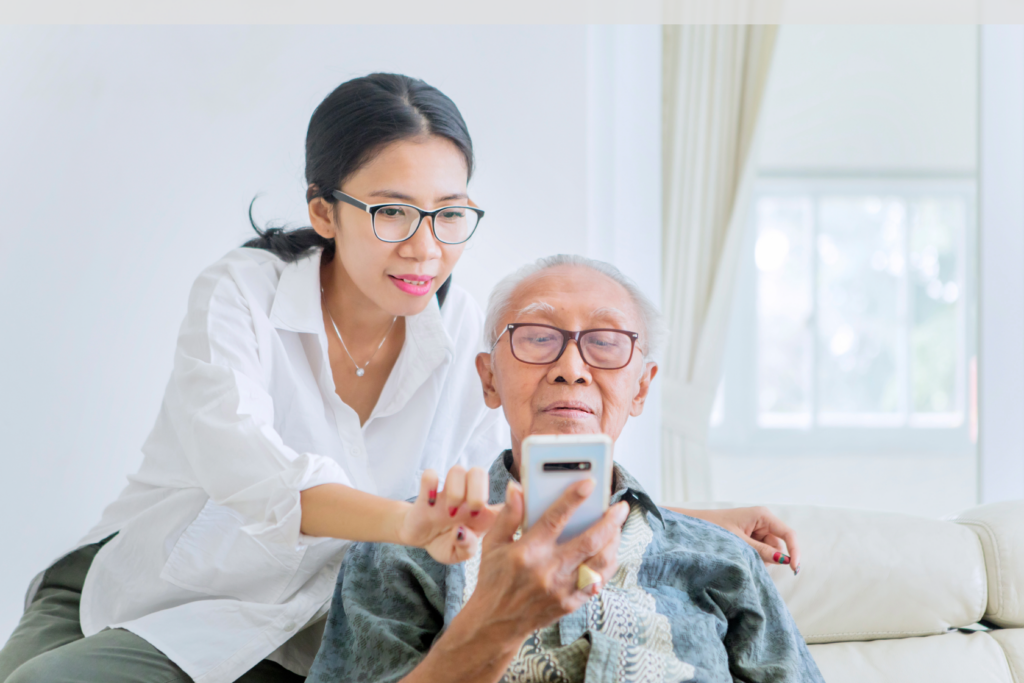 Helping elderly man with cellphone