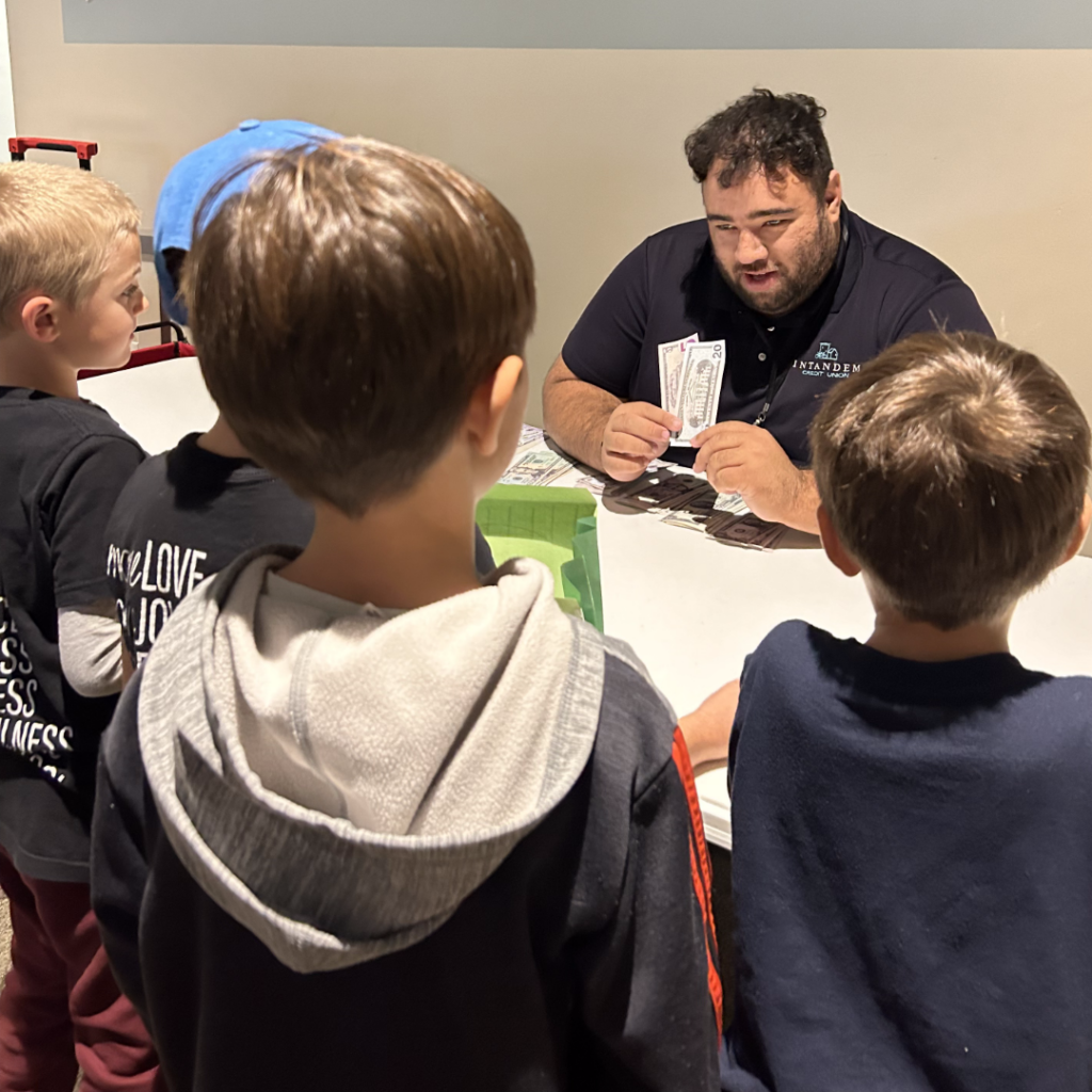 David teaching about money to a group of children