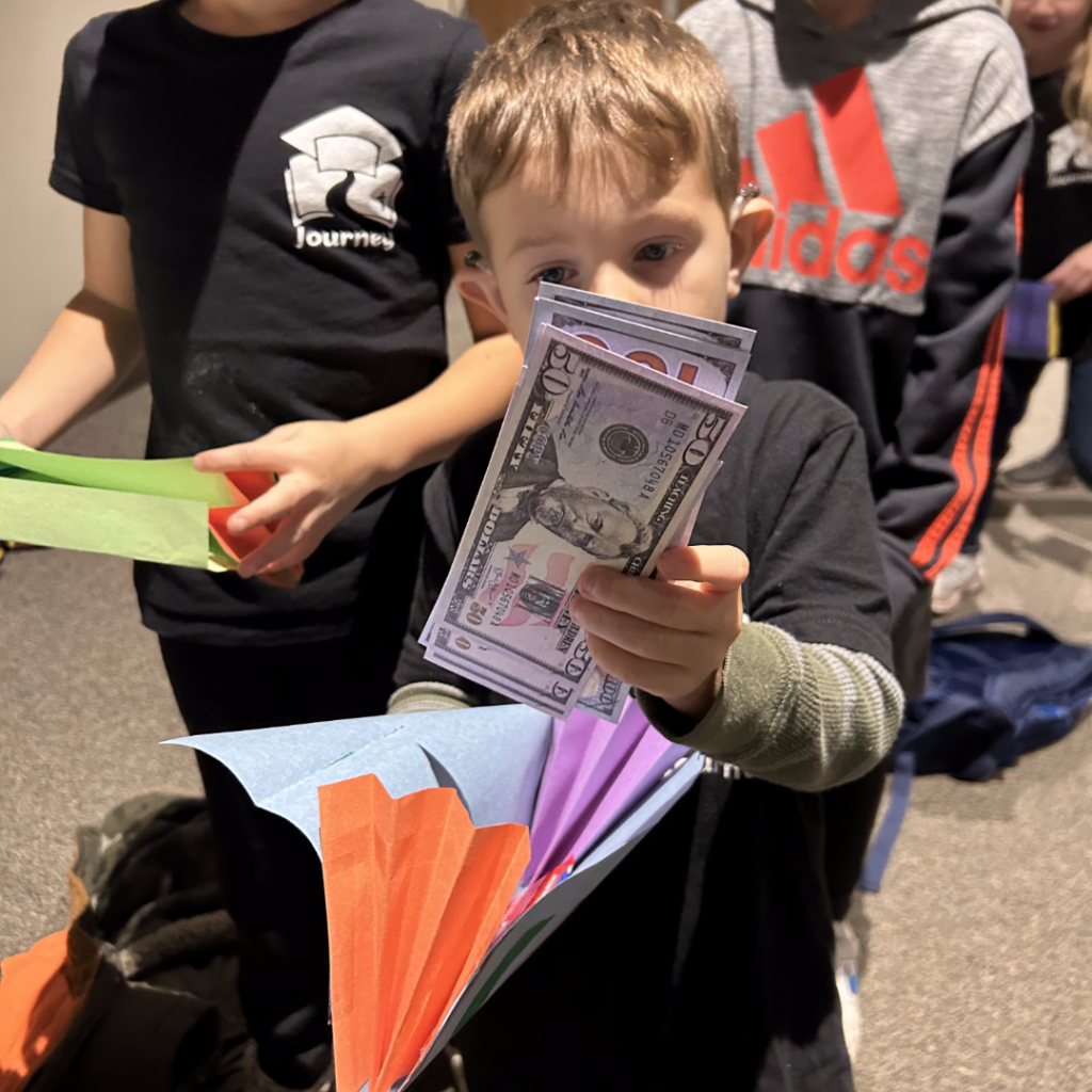 Child showing a handful of money