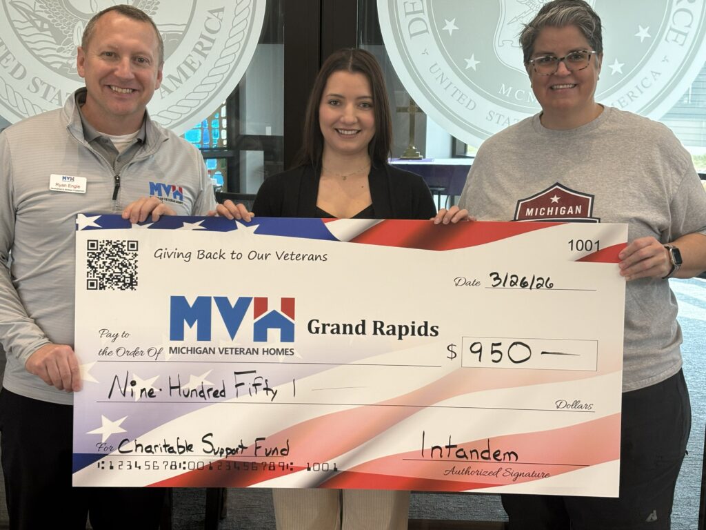 Val presenting a check for funds raised to support the Michigan Veteran Homes of Grand Rapids