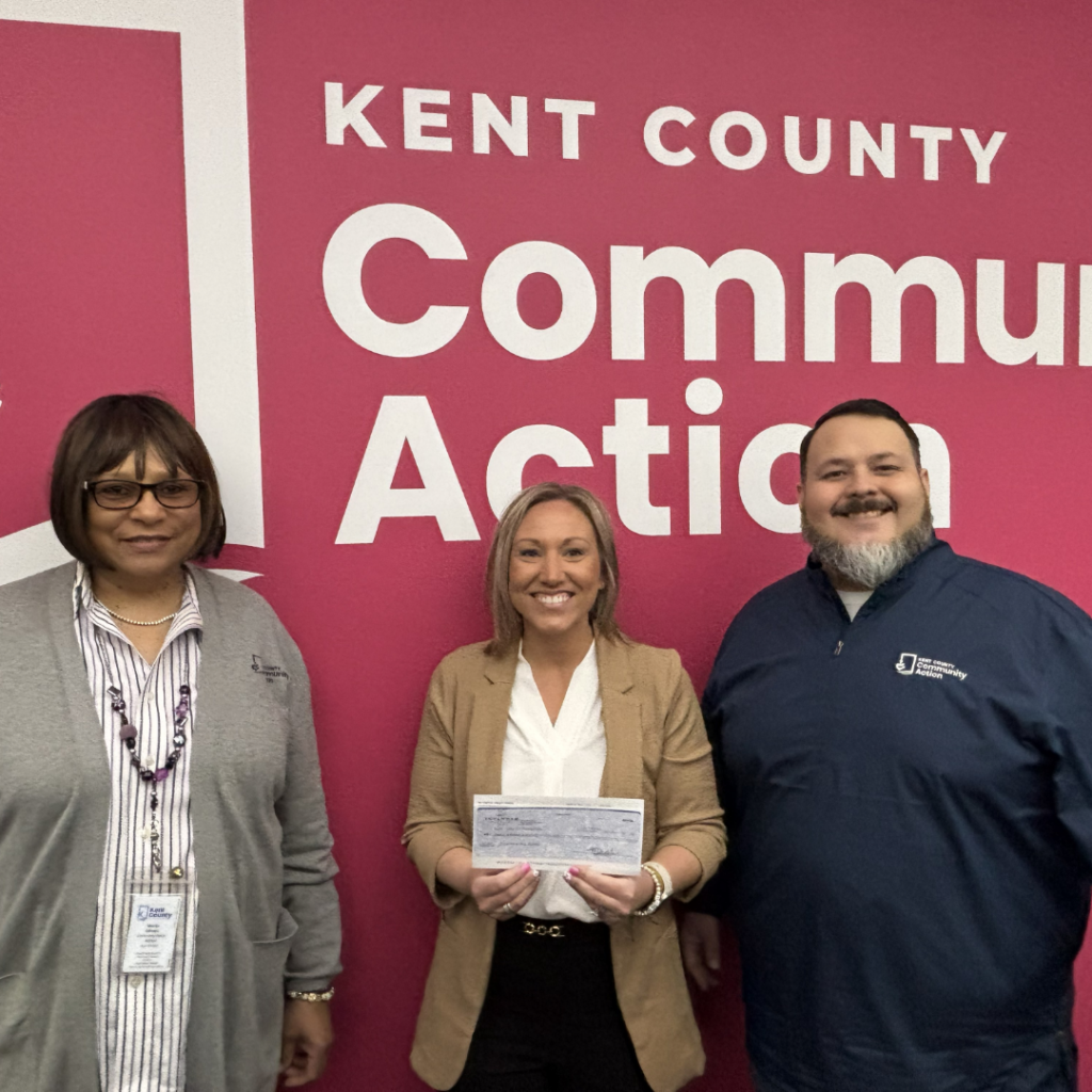 Jayne presenting a check to Kent Community Action in Support of Walk for Warmth Event in February.