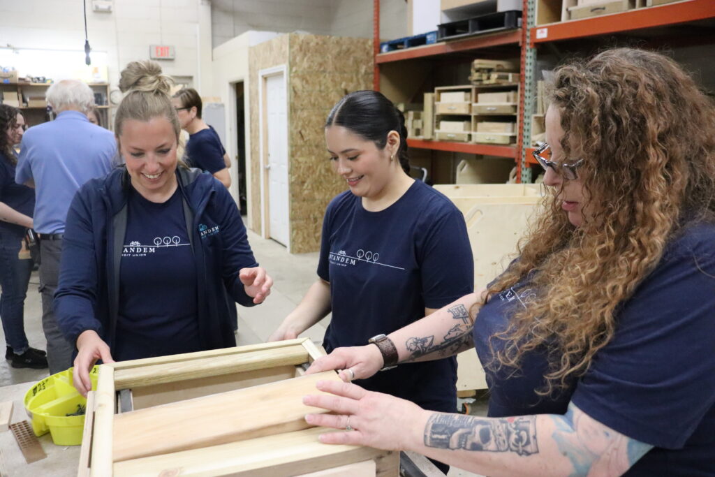 Intandem Credit Union employees participating in a hands-on volunteer project supporting Home Repair Services.