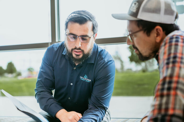 An Intandem employee discussing loans with a client.
